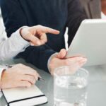 two individuals reviewing tax deductions